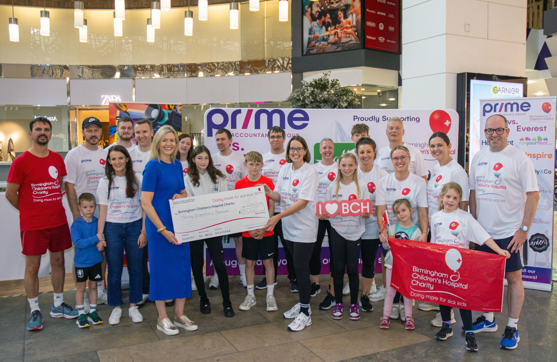 The Prime Accountants Group team with the cheque for Birmingham Children’s Hospital after the Prime vs Everest challenge at the Touchwood Shopping Centre in Solihull