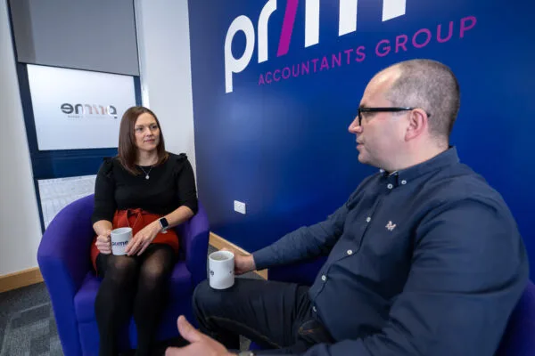 Paislei-Godley-and-Morgan-Davies-600×400.jpg Two Prime accountants staff talking while seated and holding a cup of drink